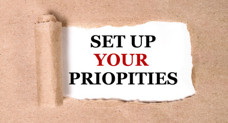 set up your priopities. text on white paper on torn paper