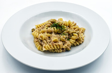 Fusilli with tuna and parsley, italian pasta, isolated on white background. 