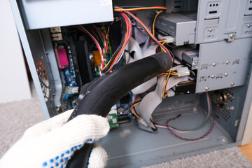A technician cleaning a computer system box, HDD with vacuum cleaner, hoover from dust and dirt, diy and computer maintenance concept