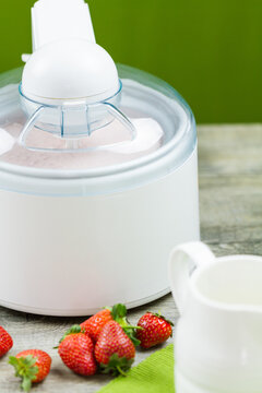 Ice cream maker machine making strawberry ice cream