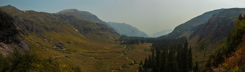 Fototapeta premium Mountain valley panorama with smoke haze, Colorado