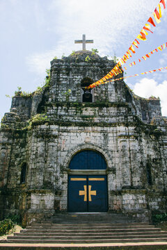 Ancient christian church with moss and plants in Catanduanes, Philippines