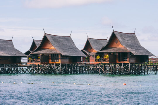 Water bungalows - huts on a hotel resort on the sea on exotic tropical island