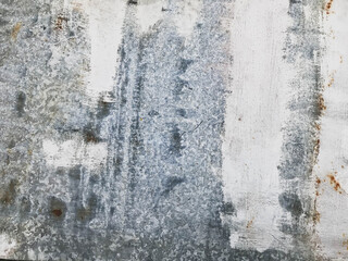 metal texture. against a background of beige smudges, rust, corrosion of a metal sheet. traces of paint got on the metal when painting the wall of the house. building's facade