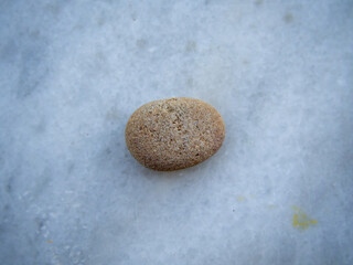 oval brownstone on the white marble background