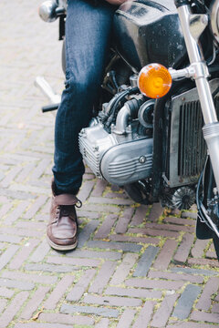 Close up of a motorsyclists boot and jeans while sitting on his motor
