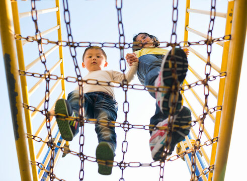 Mother and kid walking on chain net
