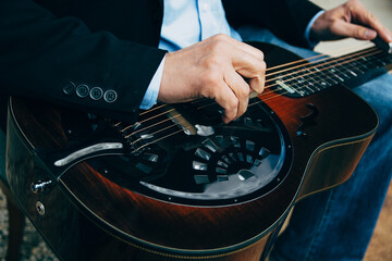 Closeup of A Male Musician's Hands Playing Slide Guitar