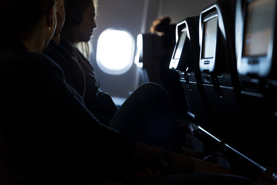 Silhouette of passengers watching in-flight entertainment