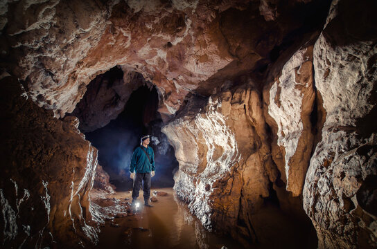 Man explorer speleologist in underground cave