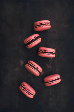 Raspberry macaroons on a black background