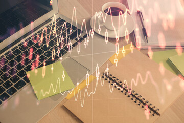 Naklejka premium Multi exposure of forex graph drawing and desktop with coffee and items on table background. Concept of financial market trading