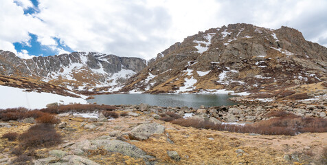 Fototapeta na wymiar Walking around a frozen lake in the Rockies Chicago Lakes area of Colorado
