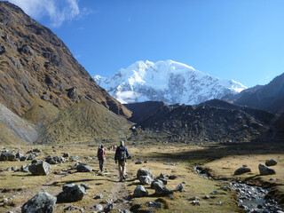 Hikers on the Salkantay trek in Peru, with snow capped mountains in the distance
