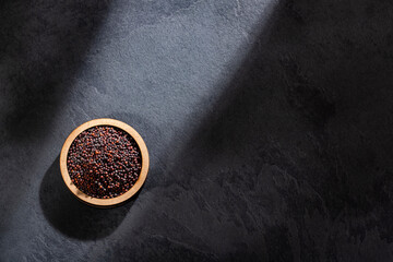 Obraz na płótnie Canvas Brassica nigra - Black mustard seeds in wooden bowl