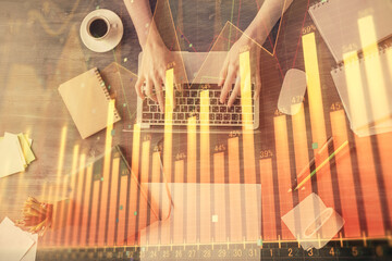 Multi exposure of woman hands working on computer and forex chart hologram drawing. Top View. Financial analysis concept.