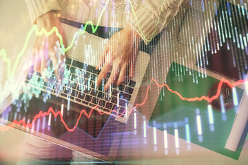 Double exposure of woman hands working on computer and forex chart hologram drawing. Top View. Financial analysis concept.