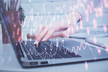 Multi exposure of woman hands typing on computer and forex chart hologram drawing. Stock market analysis concept.