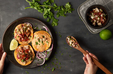 Woman serving fish ceviche with toasts