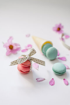 Pink and blue macaroons on white background