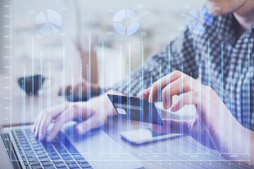 Double exposure of man hands holding a credit card and Forex graph drawing. Stock trading and digital fintech in Internet E-commerce concept.