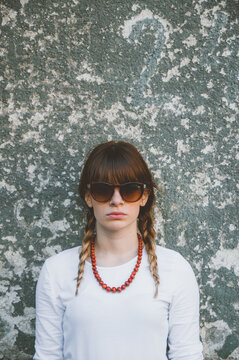 Portrait of young beautiful woman in front of grunge background