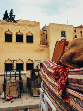 Stack of Mattresses in Front of Yellow House in North Africa