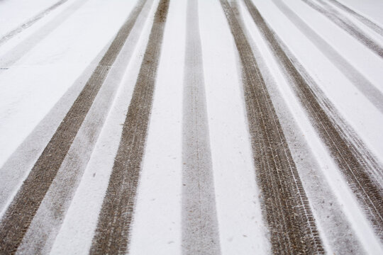 Snowy road with traces of cars