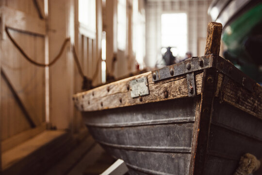 Old wooden fishing row boat in a museum