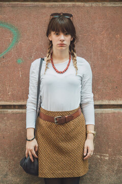 Portrait of young beautiful woman in front of grunge background