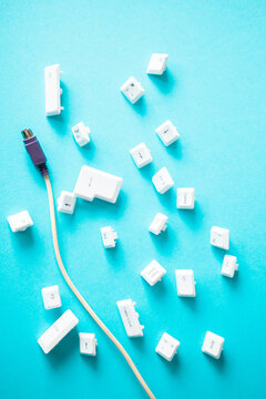 Separated pc keyboard buttons with input cabel on blue background