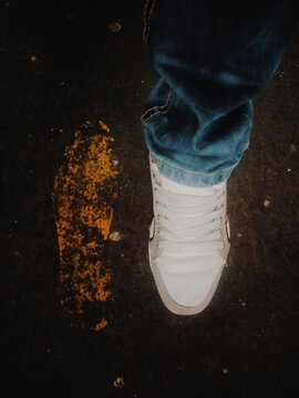 Casual Shoe Besides a Yellow Footprint