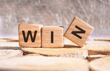 The word Win written in black letters on wooden blocks. Business, motivation and education concept