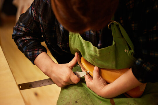Shoemaker making leather shoes
