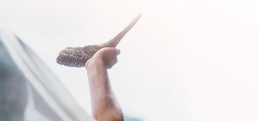 Happy Yom Kippur.Happy new year.Jewish man in Tallit blowing the Shofar (horn) of Rosh Hashanah (New Year Jew).Religious and Holidays in israel people of GOD.Peace Pray Freedom in Israel.Banner.