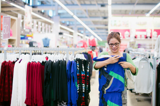Mid-adult woman shopping at large discount store