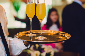 Festive bellini champagne flutes at holiday party