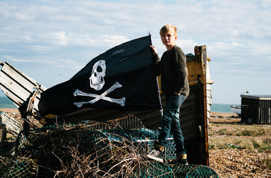 Boy, boat, pirate flag...... and all around, dereliction.
