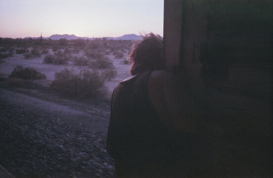Young Man in the Breeze on Moving Boxcar