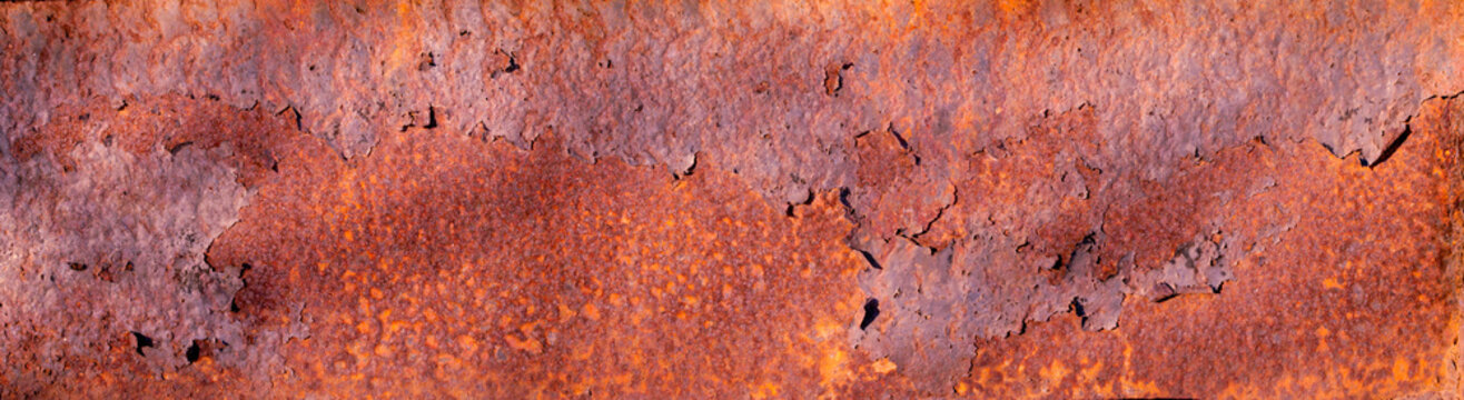 Closeup macro of the patterns colors textures of rusting deteriorating metal steel plates