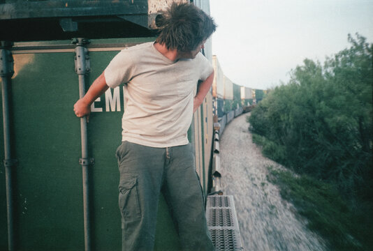 Young Man Riding a Freight Train
