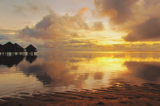 Romantic sunset at luxury resort beach, Tahiti