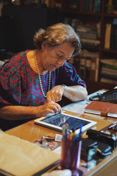 84 year old healthy woman using her tablet
