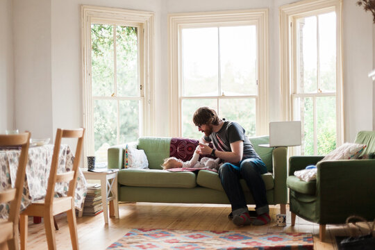 Father and Newborn Son at Home