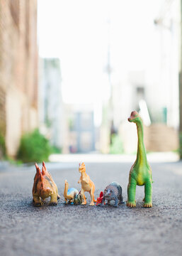 Row of colorful toy dinosaurs