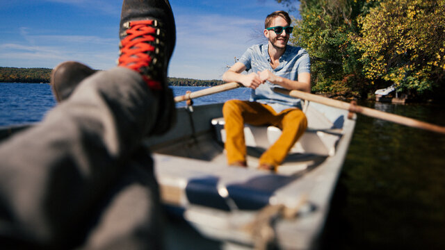 Two friends relaxing on a row boat