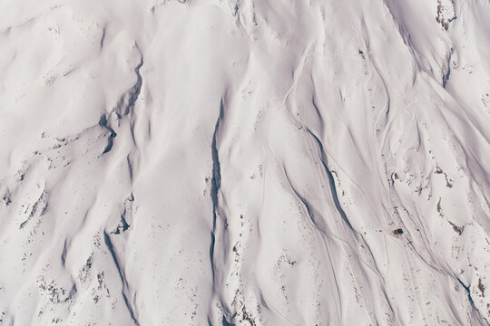Aerial view of the snow-covered mountain with ski runs