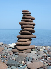 14 rocks stacked on the beach of lake superior
