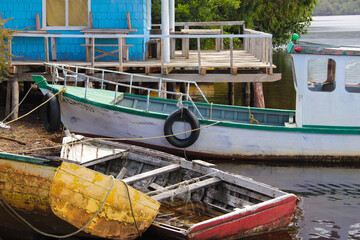 Typical colorful boats and house of Chiloe in Chile