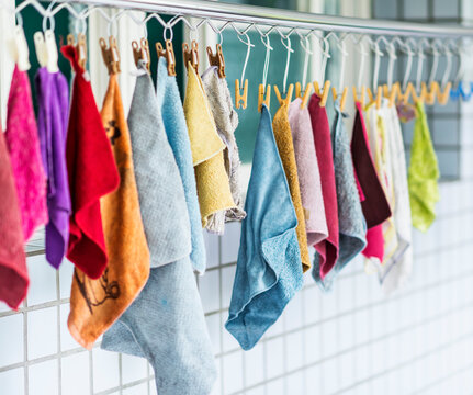 Colorful wipers hanging and drying outside window